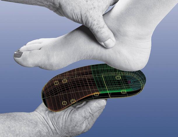A foot resting on a custom orthotic